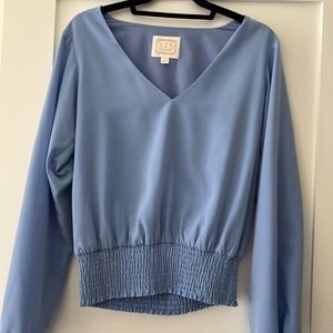 Sail to Sable smocked waist top in blue. Long blouson sleeves.